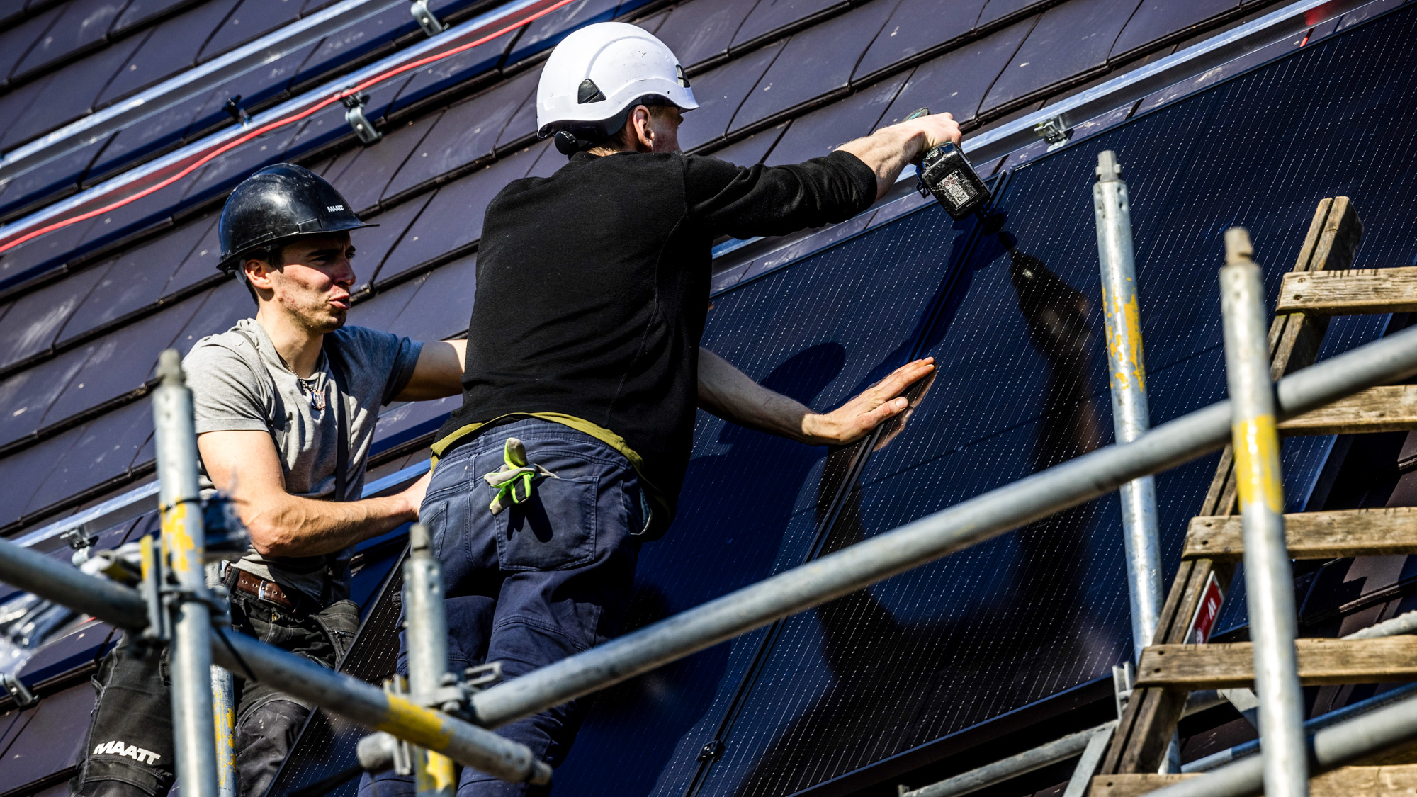 Montage van zonnepanelen in een nieuwbouwwijk.
